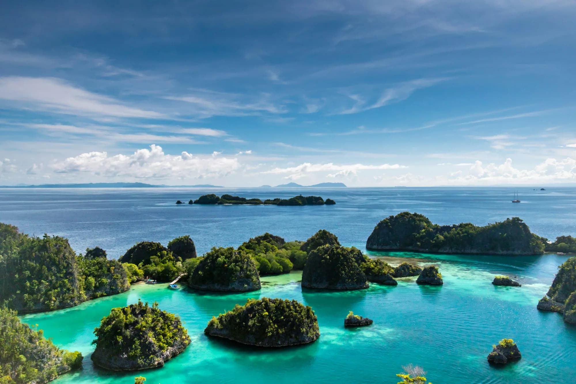 Limestone islands scattered across turquoise Indonesian water
