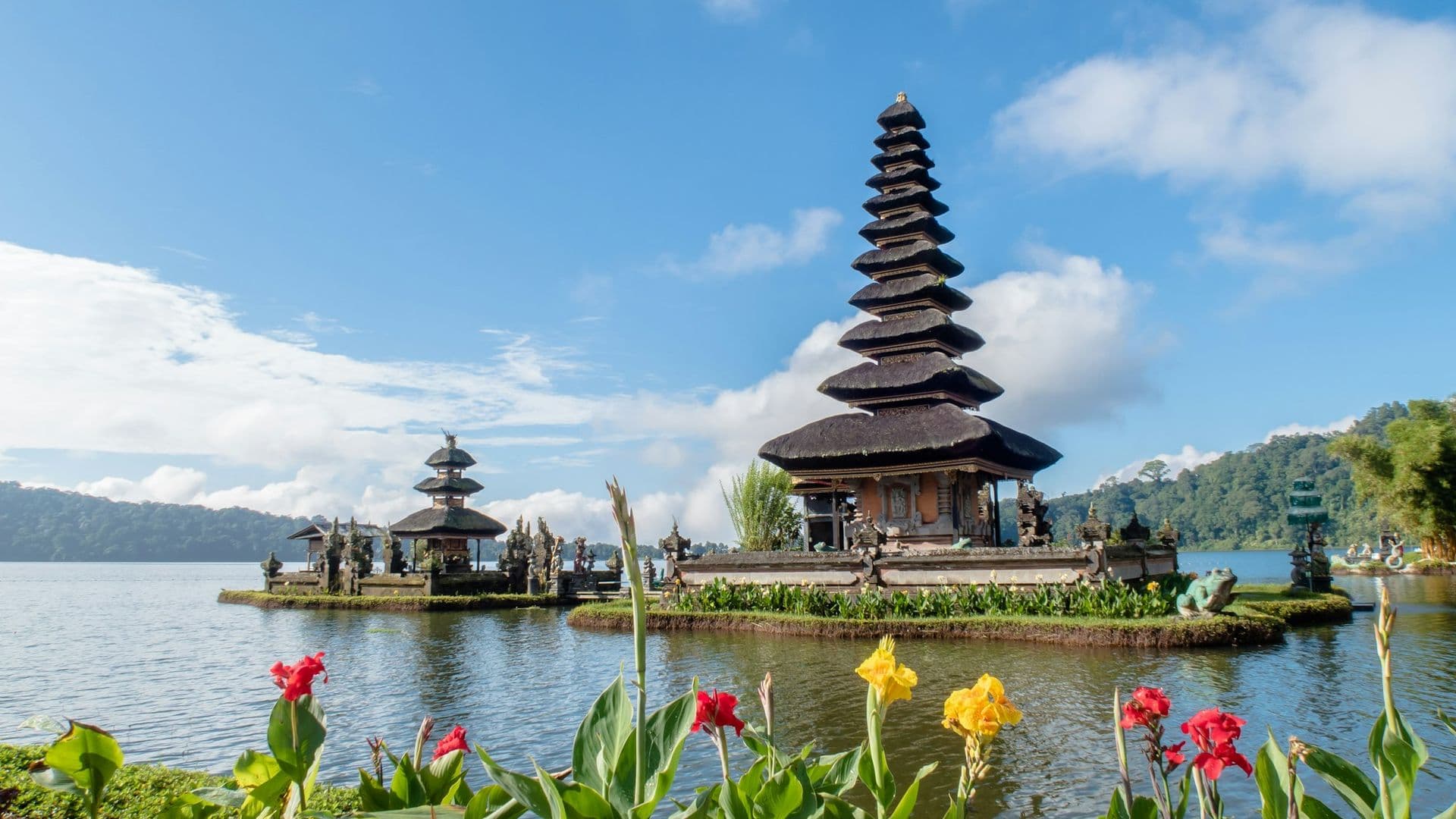 Thatched-roof resort pavilions overlooking a Bali jungle valley